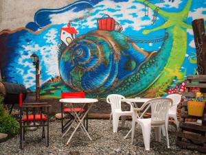 a mural on the wall of a room with tables and chairs at Nomad in San Carlos de Bariloche