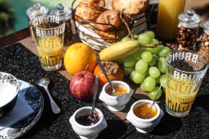 a table topped with different types of fruit and dips at Chambre d'hôtes A Vadina Porticcio in Porticcio