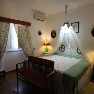 a bedroom with a bed with a canopy at Quinta do Freixo in Reguengos de Monsaraz