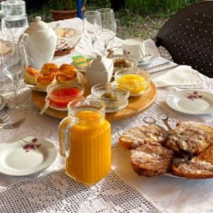 a table topped with plates of food and orange juice at Quinta do Freixo in Reguengos de Monsaraz +16 photos