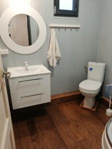 a bathroom with a toilet and a sink and a mirror at Wodamoja - apartamenty nad jeziorem in Stawiguda +74 photos