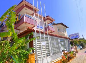 a building with a balcony on the side of it at Mykonut Apart Hotel in Fethiye