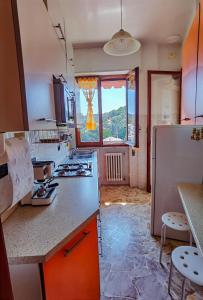 a kitchen with a refrigerator and a counter top at Luminoso appartamento vacanze vista mare in centro in Celle Ligure