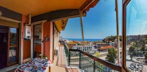 a balcony with a view of a city at Luminoso appartamento vacanze vista mare in centro in Celle Ligure