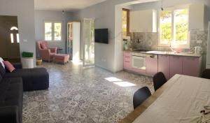 a kitchen and living room with a couch and a table at Vila Petra in Zaboric