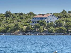 a large house on the shore of a body of water at Apartment SEA STAR in Hvar