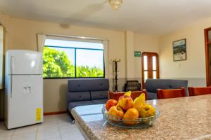 a bowl of fruit on a counter in a kitchen at Cucuve Eco Hostal in Puerto Baquerizo Moreno