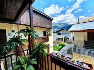 un balcone di una casa con le montagne sullo sfondo di Manoni Ratiani's Guesthouse a Mestia