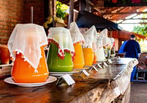 a row of drinks in plastic bags on a counter at Rancho da Cachaça Pousada in Holambra