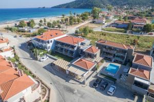 an aerial view of a coastal town with houses and the ocean at Mary's Luxury in Chrysi Ammoudia