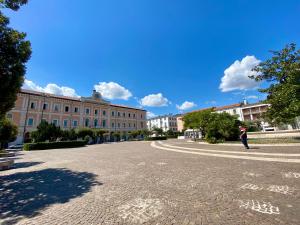 a person walking down a street in front of a building at Monfort Club B&B in Campobasso