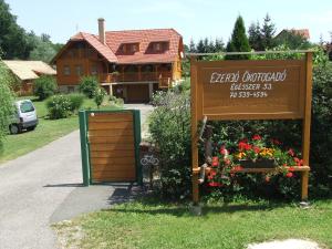 a sign in front of a house with a building at Ezerjó Ökofogadó in Őriszentpéter +9 photos
