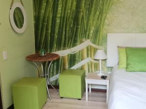 a bedroom with a bed and a bamboo wall at a Vue Guesthouse in Somerset West