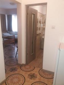 a hallway with an open door in a room at Pensiunea Sydney in Timişoara