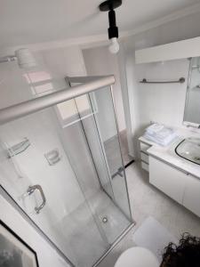 a white bathroom with a shower and a sink at Rua Dr. Diogo de Faria, 671 apto 22 in Sao Paulo +7 photos