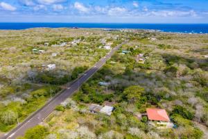 an aerial view of a road next to the ocean at Cucuve Eco Hostal in Puerto Baquerizo Moreno