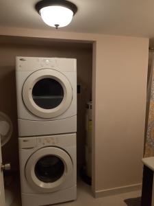 a laundry room with a washing machine and a light at The Lookout at Coral Beach in Freeport