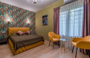 um quarto com uma cama, uma mesa e cadeiras em Constant Tbilisi em Tbilisi