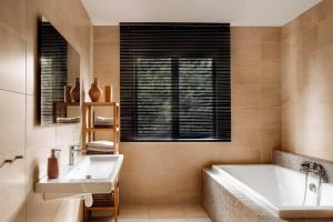 een badkamer met een bad en een wastafel bij Merveilleuses chambres d'hôtes à Panazol in Panazol