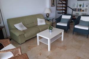 a living room with a couch and a table and chairs at S'Estel. Colònia de Sant Jordi. Mallorca in Colònia de Sant Jordi