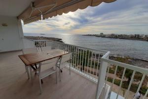 a balcony with a table and chairs and the ocean at S'Estel. Colònia de Sant Jordi. Mallorca in Colònia de Sant Jordi