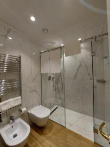 a bathroom with a shower and a toilet and a sink at Hotel Borgovico in Como