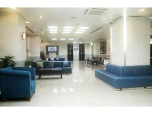 a lobby with blue couches in a hospital at Osaka Bay Plaza Hotel - Vacation STAY 44083v in Sakai