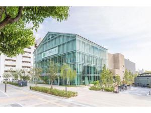 a large glass building in front of a building at Osaka Bay Plaza Hotel - Vacation STAY 44083v in Sakai