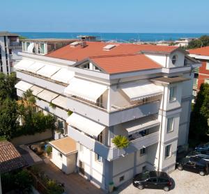 an aerial view of a white building with a red roof at Hotel Domus in Marina di Massa