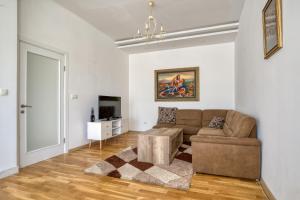 a living room with a couch and a tv at Apartman Marko in Podgorica