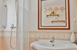 a bathroom with a sink and a mirror and a shower at SunShine Buen Pastor in Córdoba +7 photos