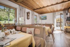 a restaurant with two tables in a room at Café Pension Koller in Brixen im Thale