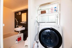 a washing machine in a bathroom with a sink at Vacation Rental NISHIDA - Vacation STAY 61687v in Kagoshima