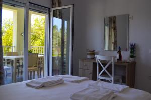 a bedroom with a bed and a table and chairs at Villa Bloom in Achladies