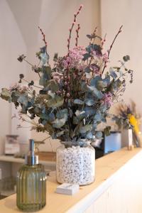 a vase filled with flowers sitting on a counter at Marosi Boutique Hotel in Ciutadella