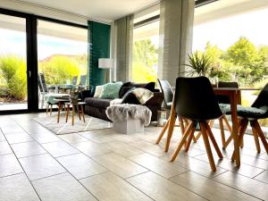 a living room with a couch and a table and chairs at Ferienwohnung Tanja in Engen