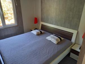 a bedroom with a large bed with two pillows at SRB Sadovo-Resort-Bulgaria in Sadovo +34 photos