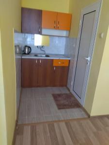 a small kitchen with a sink and a counter at Фамилна къща Джоко in Kiten