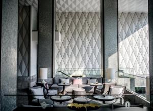 a rendering of a lobby with tables and chairs at InterContinental Phuket Resort by IHG in Kamala Beach
