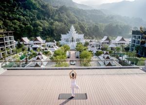 a woman standing on the roof of a building at InterContinental Phuket Resort by IHG in Kamala Beach