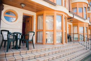 a porch with chairs and a table on a house at Apartamentos Torre Cristina in Noja