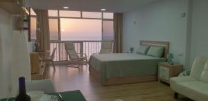 a bedroom with a bed and a balcony with a view at Salitre Suite in Tacoronte