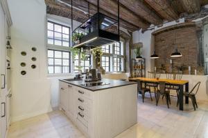 an industrial kitchen with a dining area and a table at Rataskaevu 14 in Tallinn