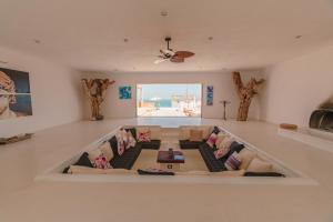 a living room with couches and a ceiling fan at The White Lodge in San José del Cabo