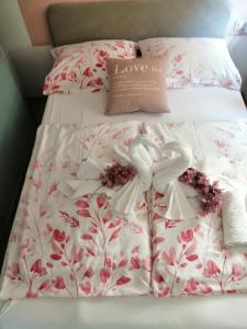 a bed with two heart shaped pillows on it at Sun & Love Apartment in Koper