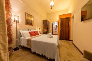 1 dormitorio con 1 cama grande con manta blanca en Rede Reserva Santa Teresa en Río de Janeiro