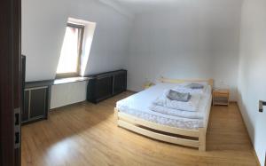 um quarto com uma cama e uma janela em NAD GALERIĄ em Duszniki Zdrój
