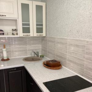 a kitchen counter with a sink and a cake on it at fantasy park in Ventspils +39 photos
