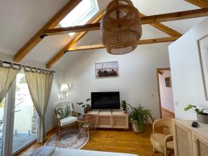 a living room with a flat screen tv at House 1960 in Lin