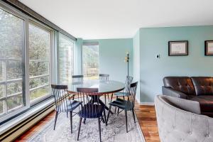 a dining room with a table and chairs and a couch at Simba Run in Vail